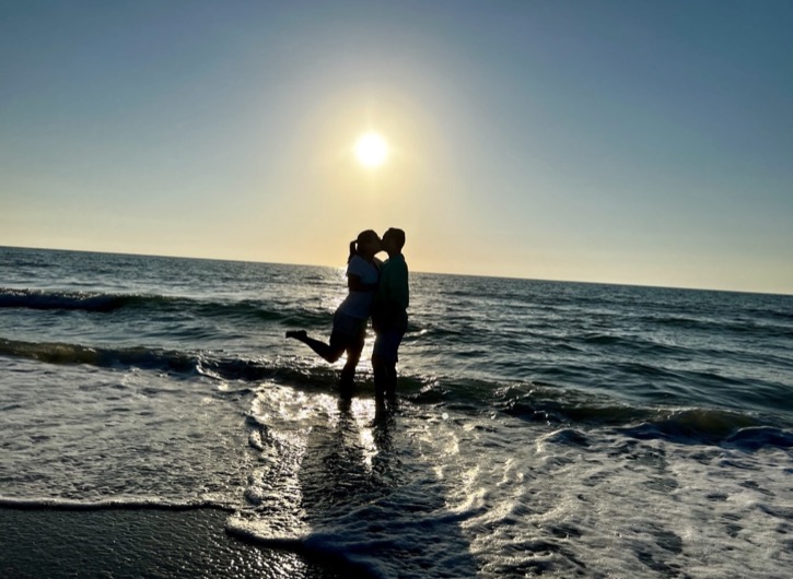 Brandon and Tiffany sharing a kiss at sunset in Florida